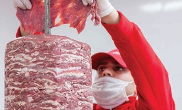 After marination process, finely sliced meats are carefully skewered on a long solid rod.